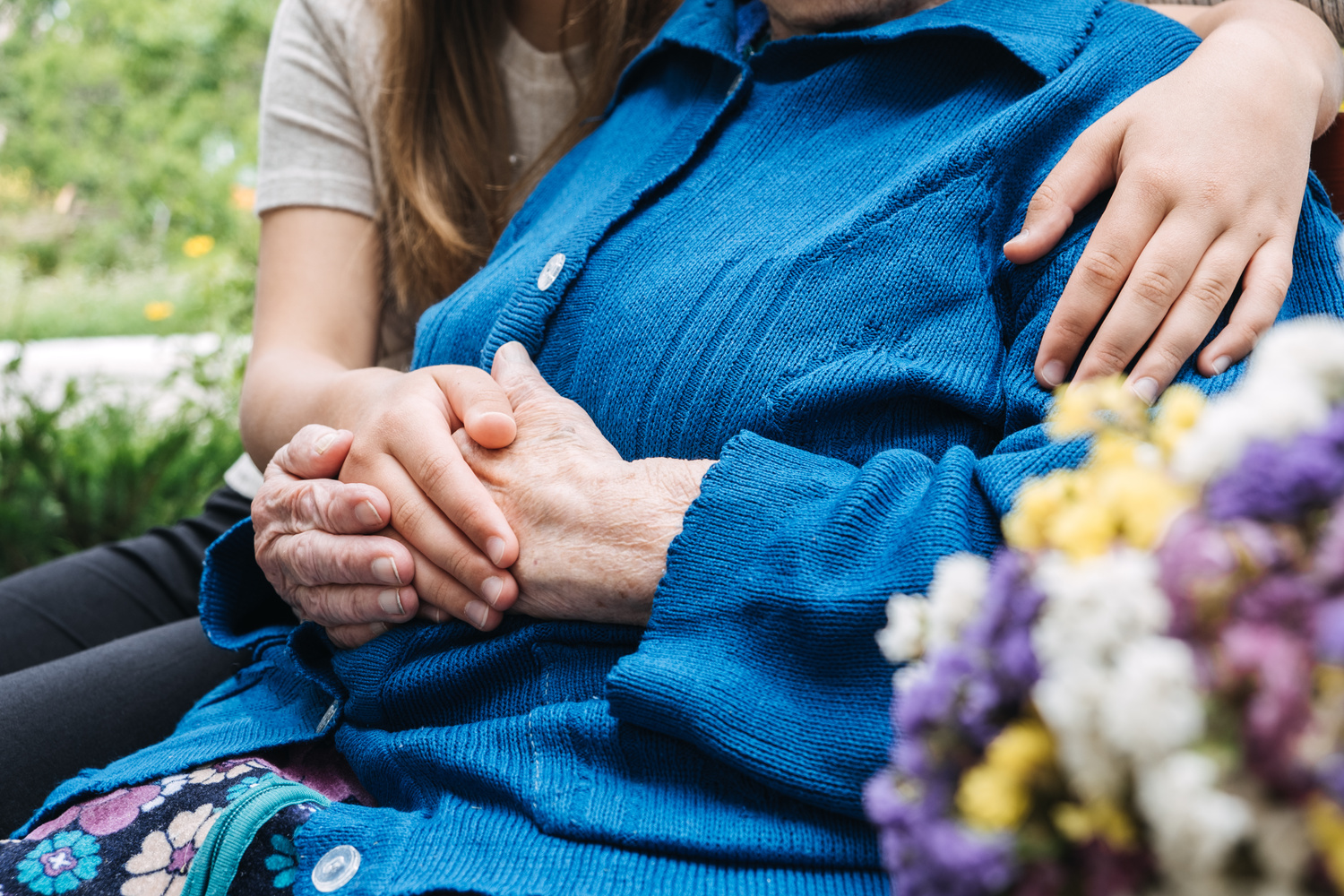 Charities for Elderly People. Young hands holding old elderl